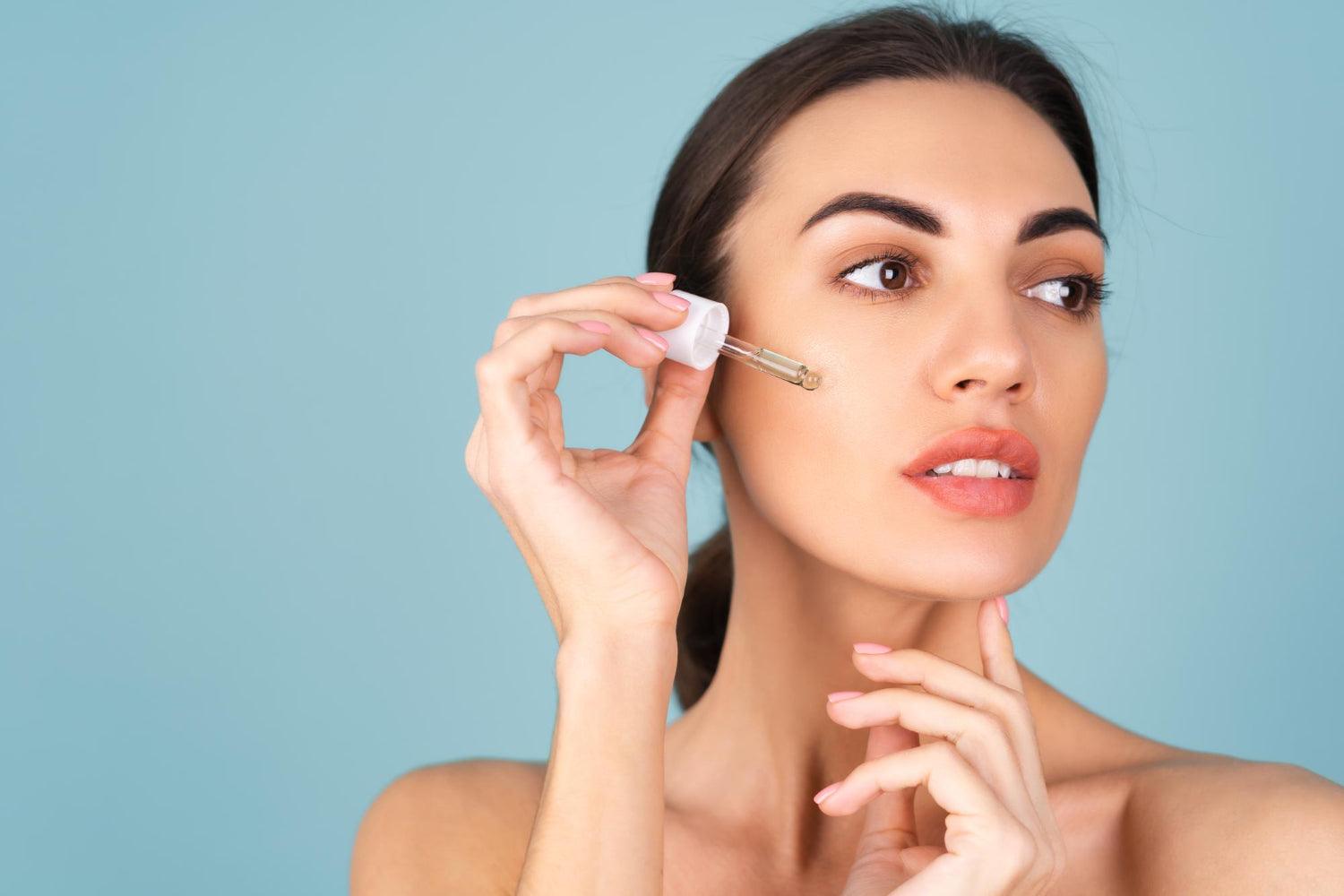 Woman holding a serum dropper