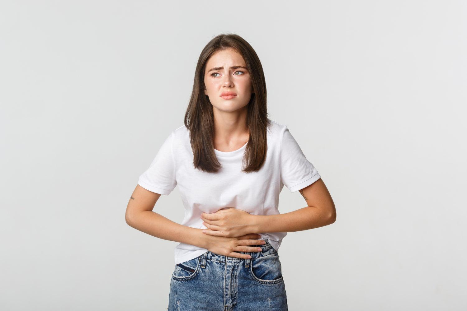 Woman holding her stomach due to pain